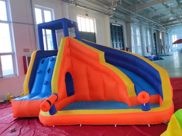 Vibrant inflatable slide with climbing wall and play area, perfect for kids' parties and events. Durable and fun. Buy online in Australia today!